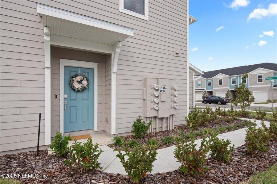 Exterior details and patio area of a home in Hardwick Farms: Hardwick Farms - Townhome Collection, Jacksonville (Image 28).