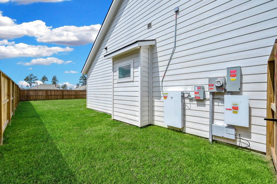 Exterior details and patio area of a home in Spring Branch Crossing, Conroe (Image 26).