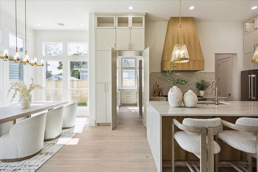 This custom home is full of surprises. Tucked just behind the kitchen, the hidden pantry keeps everyday essentials close at hand while preserving the clean, polished look of the main living spaces, and a nearby mud room adds even more everyday convenience.