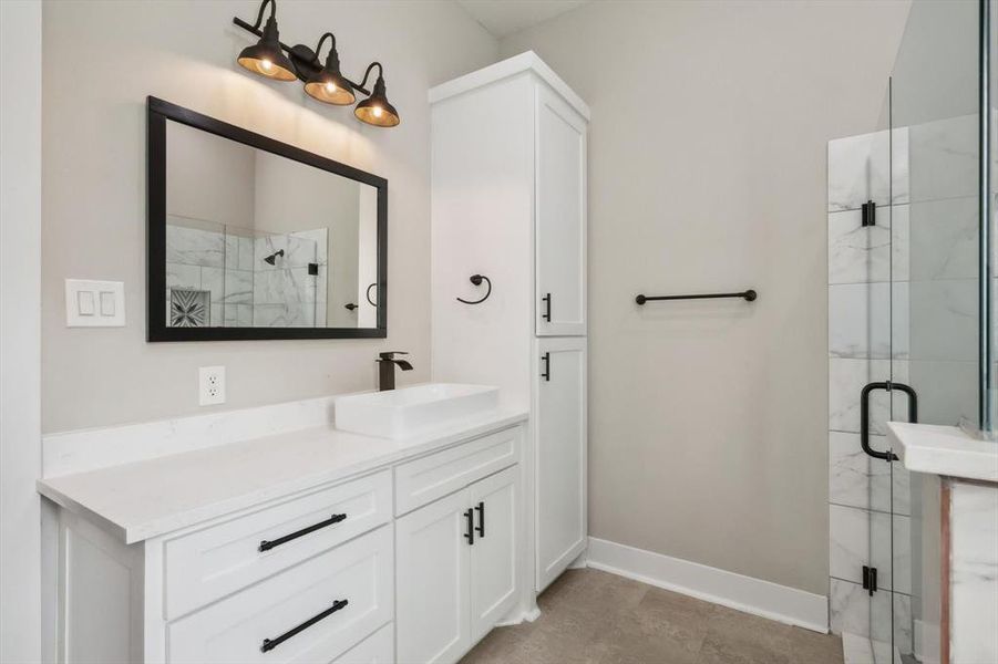 Bathroom featuring walk in shower and vanity