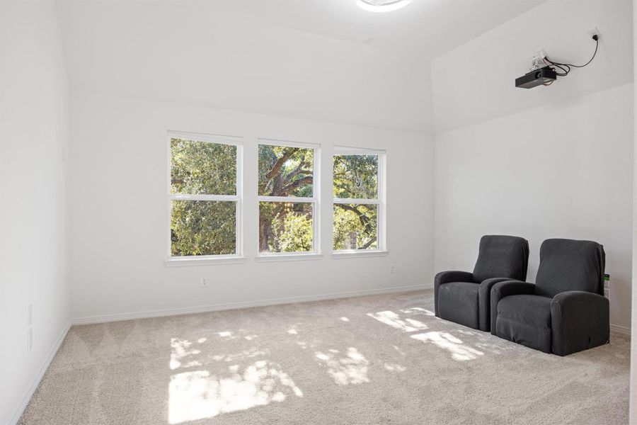 Sitting room featuring carpet and baseboards Sitting room featuring carpet and baseboards