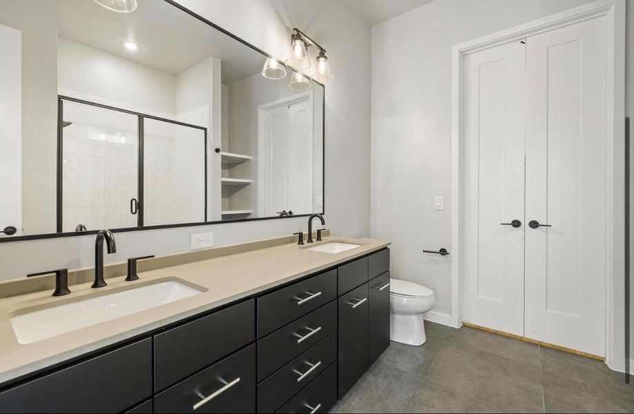 Clean lines and a spacious double vanity anchor this modern bathroom design. Clean lines and a spacious double vanity anchor this modern bathroom design.