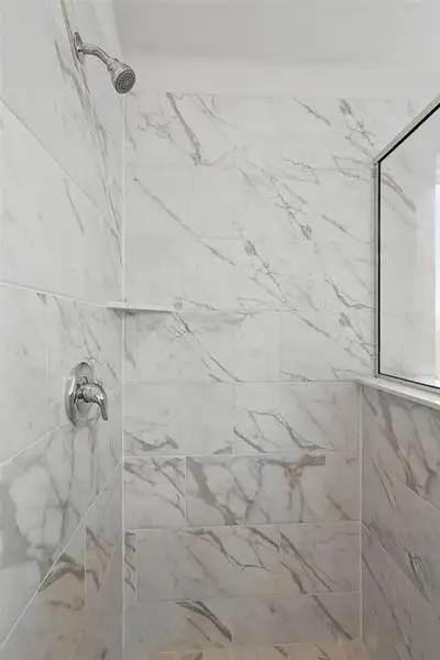 Bathroom featuring tiled shower