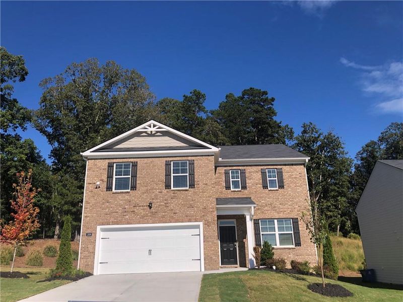 Front exterior of a new home in Brooks Village, Dacula, GA, highlighting curb appeal (Image 1).