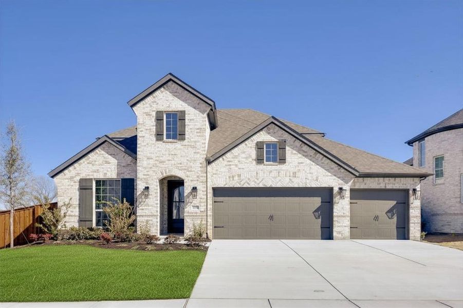 Light brick exterior with dark shutters, dual garage doors, and a concrete driveway
