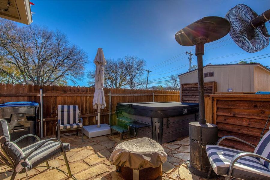 View of patio with a hot tub