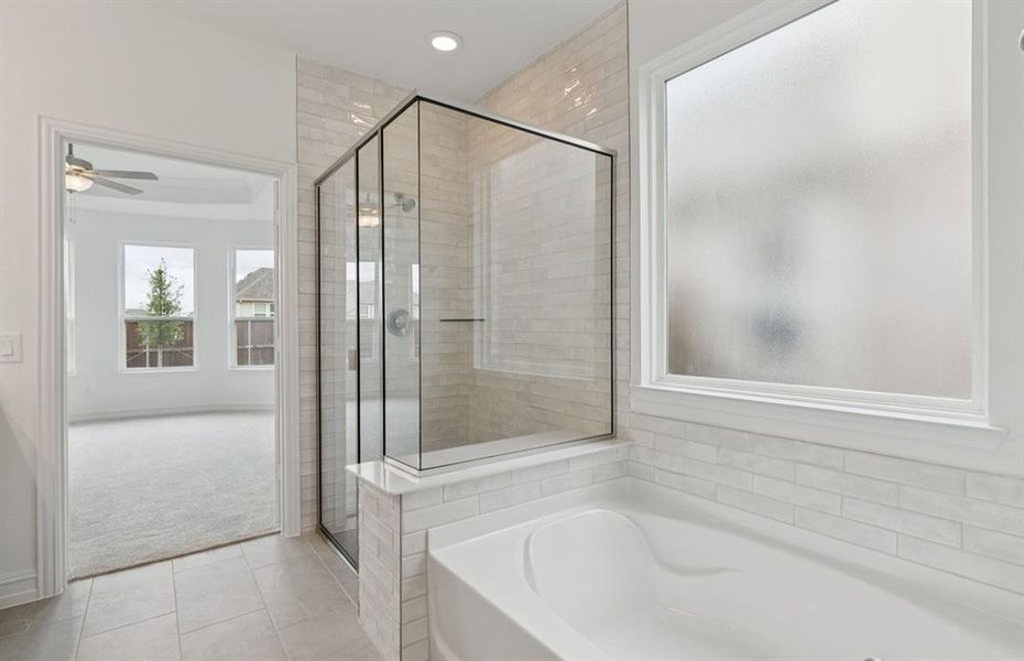 Luxurious owner's bath complete with double sinks and a generous shower  *Real home pictured