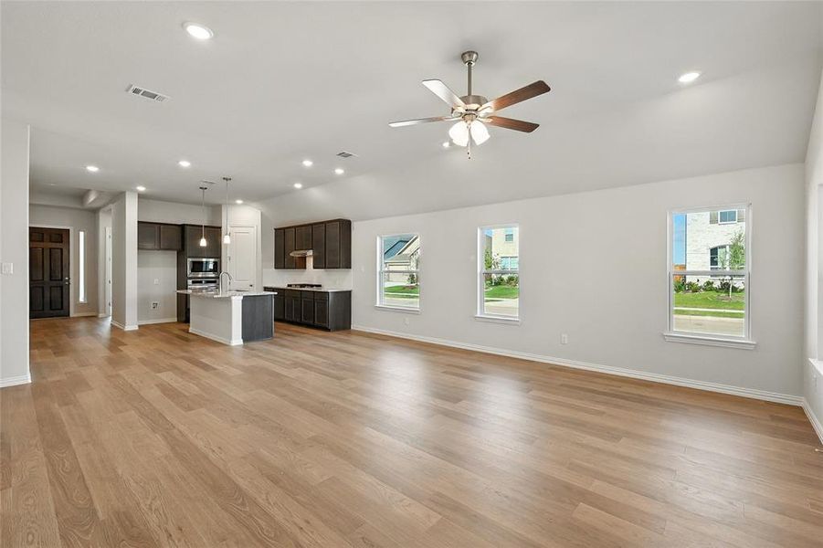 Unfurnished living room featuring ceiling fan, light wood finished floors, and recessed lighting