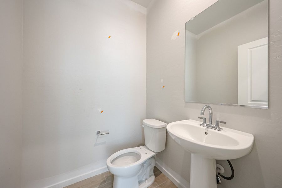 A bathroom with a toilet and sink. A bathroom with a toilet and sink.