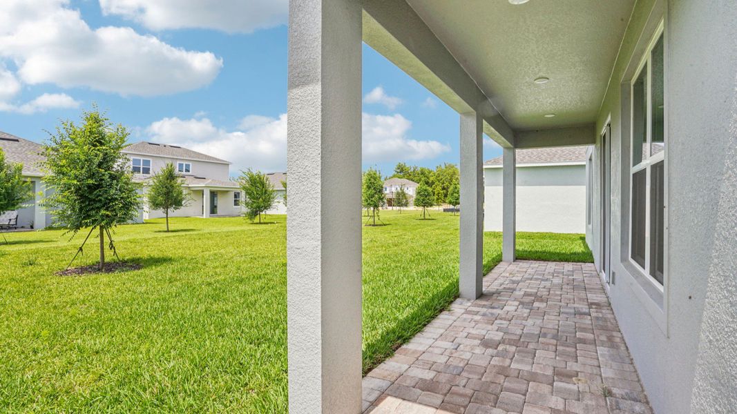 Covered lanai with scenic backyard views in the Plumeria plan at Lakeside at Satilla by DRB Homes. Covered lanai with scenic backyard views in the Plumeria plan at Lakeside at Satilla by DRB Homes.