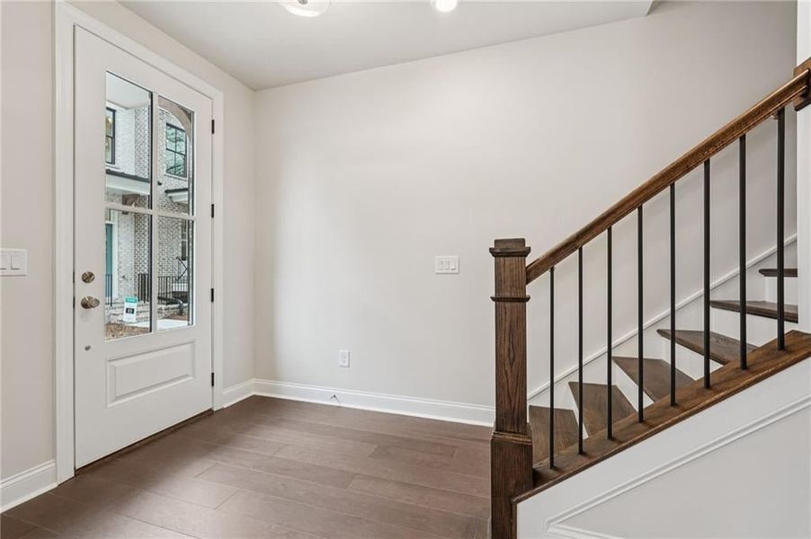 Foyer entrance with hardwood flooring and stairs- open rail details. Hardwoods Piedmont Hickory - Dogwood