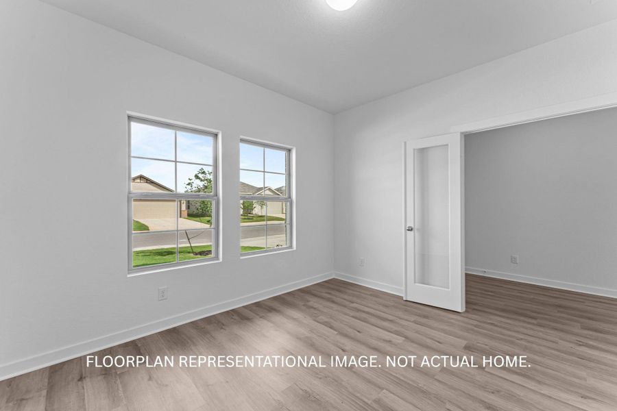 A well-lit interior space features resilient flooring and ample natural light from multiple windows.