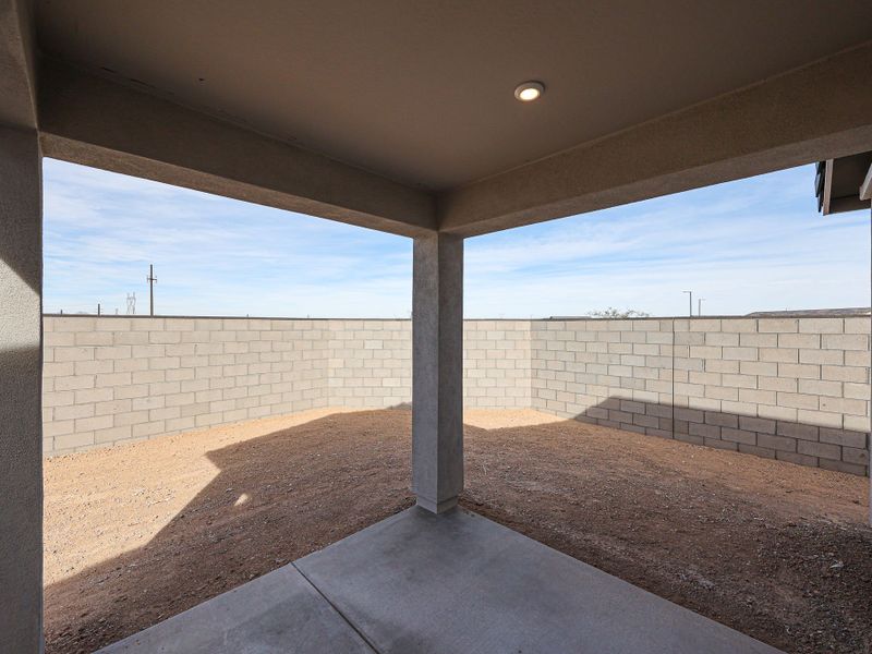 A brick wall with a concrete floor.