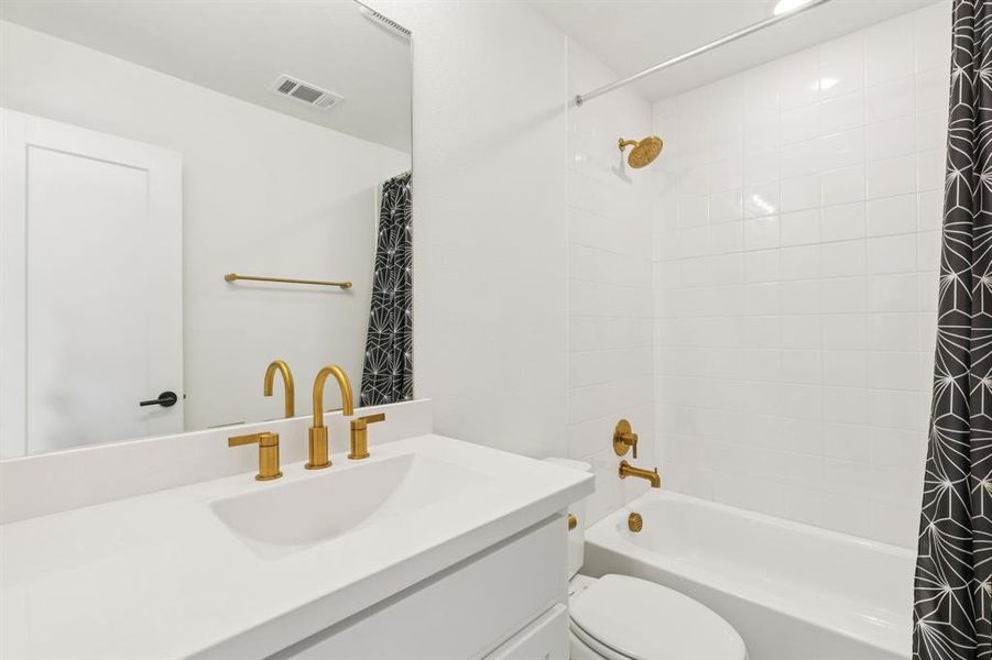 Bathroom featuring vanity and shower / bath combo