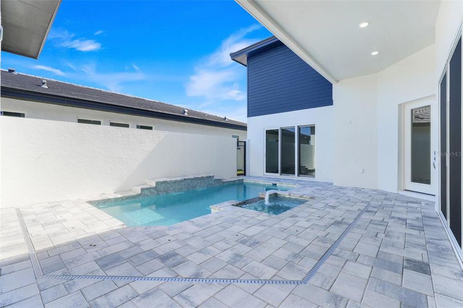 Exterior details and patio area of a home in Hampton Green at Providence, Davenport (Image 30).