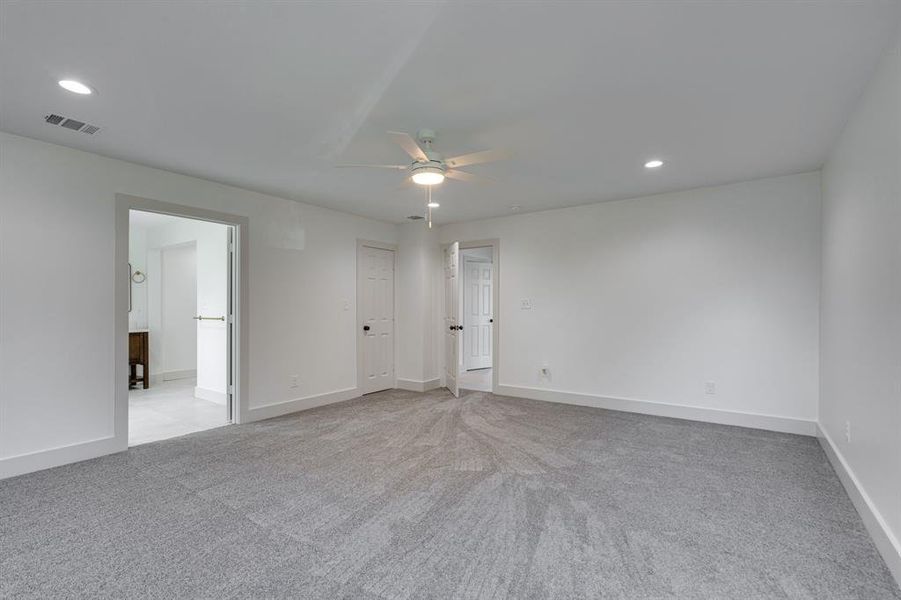 Unfurnished bedroom featuring ceiling fan and light carpet