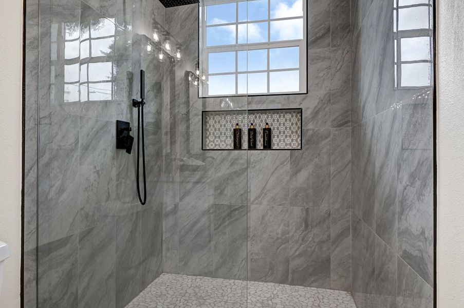 Indulge in a spacious, high-end walk-in shower featuring elegant tilework and modern fixtures. Indulge in a spacious, high-end walk-in shower featuring elegant tilework and modern fixtures.