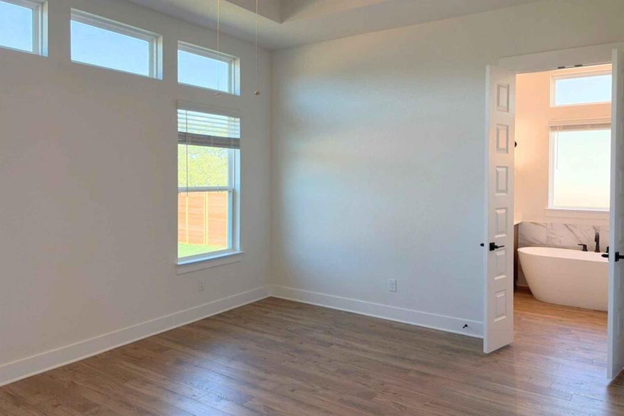 Empty room featuring baseboards and dark wood-type flooring Empty room featuring baseboards and dark wood-type flooring
