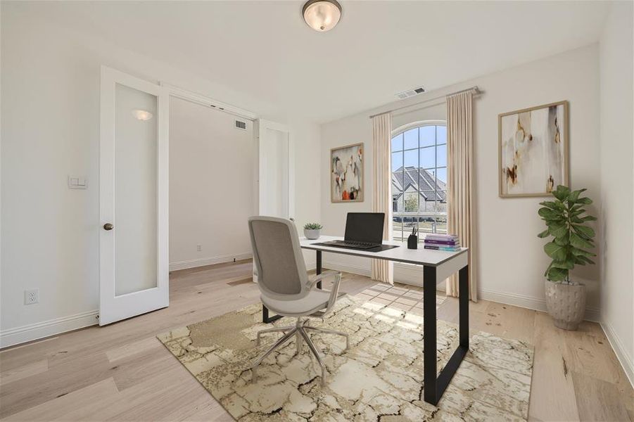 Virtually Staged Photo - Home office with light hardwood / wood-style floors