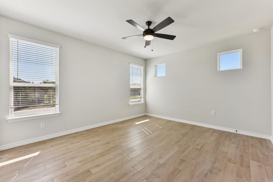 Spare room with light wood-type flooring and a ceiling fan