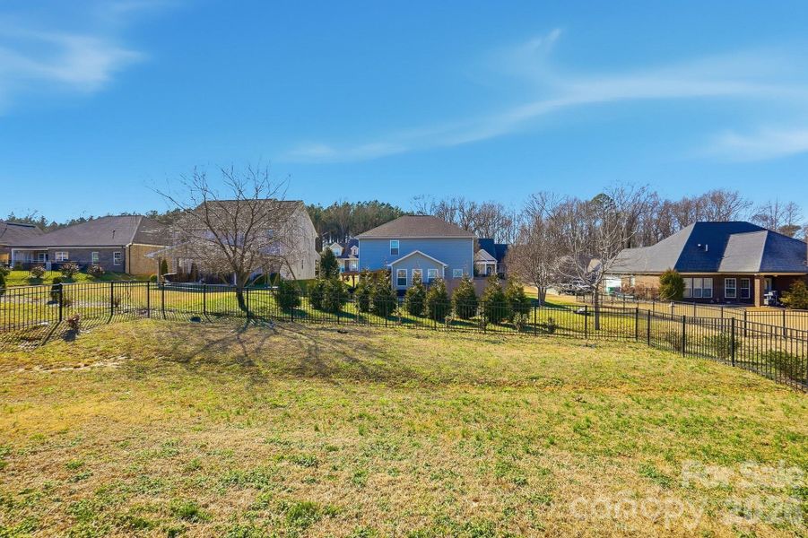 several trees have been planted along the perimeter of the fence.