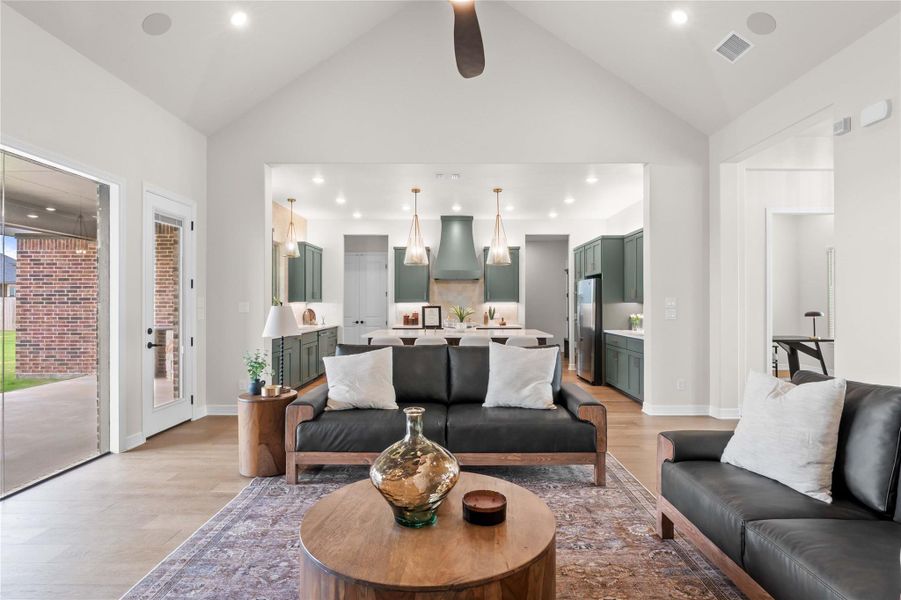 Vaulted ceilings amplify the open-concept living space, flowing seamlessly into a gourmet kitchen. Vaulted ceilings amplify the open-concept living space, flowing seamlessly into a gourmet kitchen.
