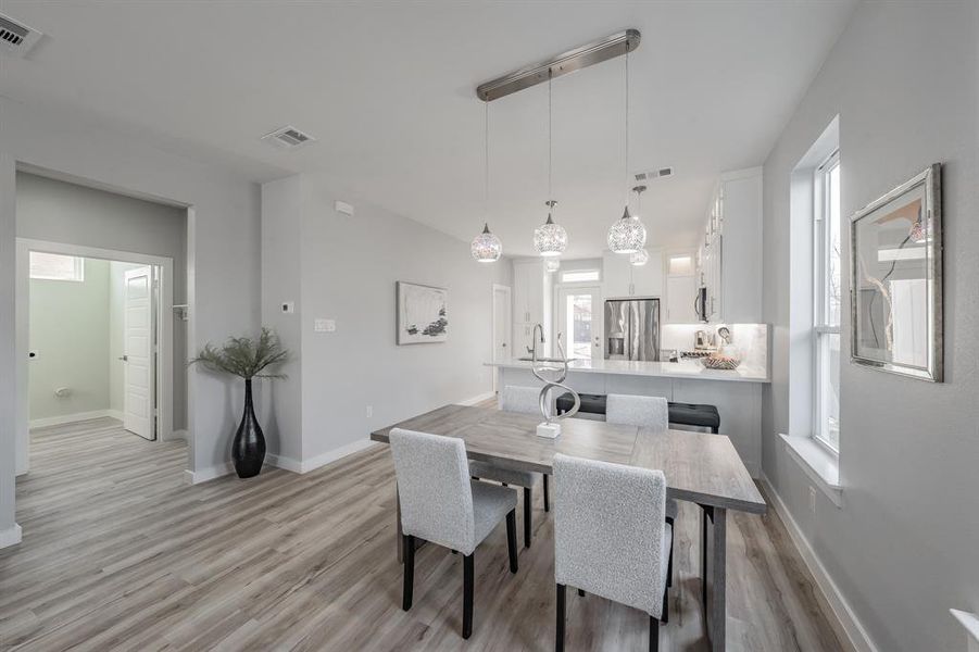 Dining area with light wood-type flooring