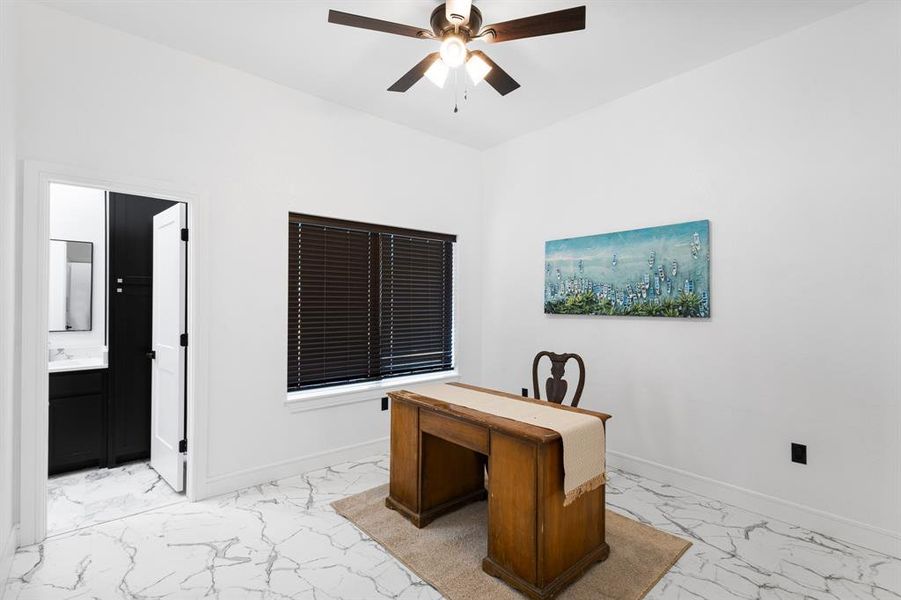 Office with light marble finish flooring and ceiling fan