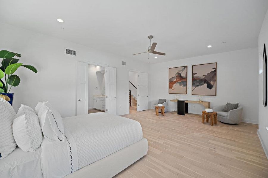 Bedroom with recessed lighting, light wood-type flooring, ceiling fan, and connected bathroom