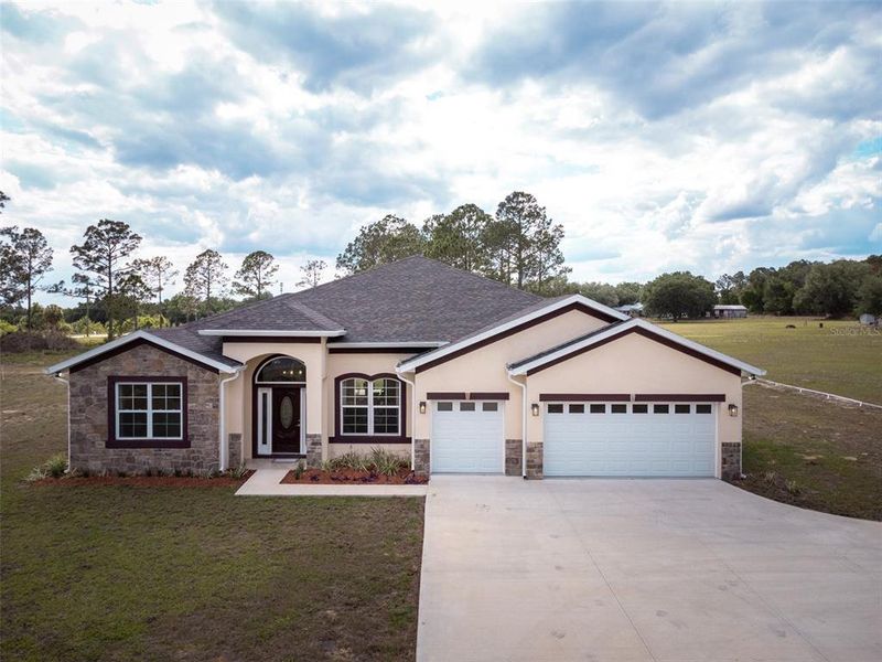 Front exterior of a new home in , Leesburg, FL, highlighting curb appeal (Image 25).