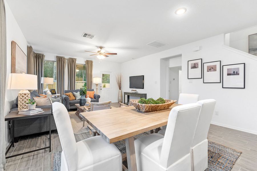 A dining room with a table and chairs. A dining room with a table and chairs.