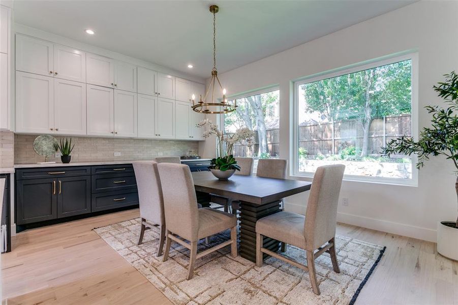 Dining area featuring light hardwood / wood-style flooring and an inviting chandelier