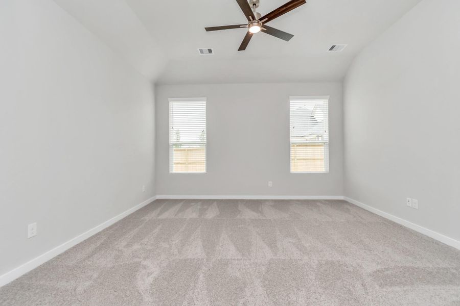Another perspective unveils a comprehensive view of the serenity and comfort this primary suite offers. Sample photo of completed home with similar floor plan. Actual colors and selections may vary.