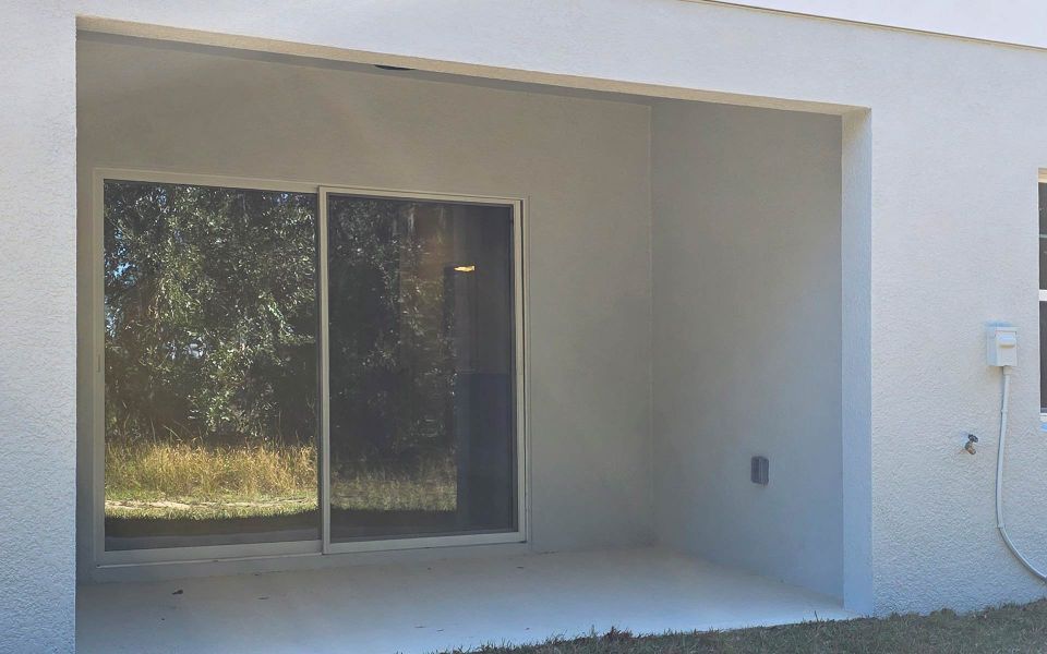 Exterior details and patio area of a home in Blue Springs Reserve Townhomes, Groveland (Image 3). Exterior details and patio area of a home in Blue Springs Reserve Townhomes, Groveland (Image 3).