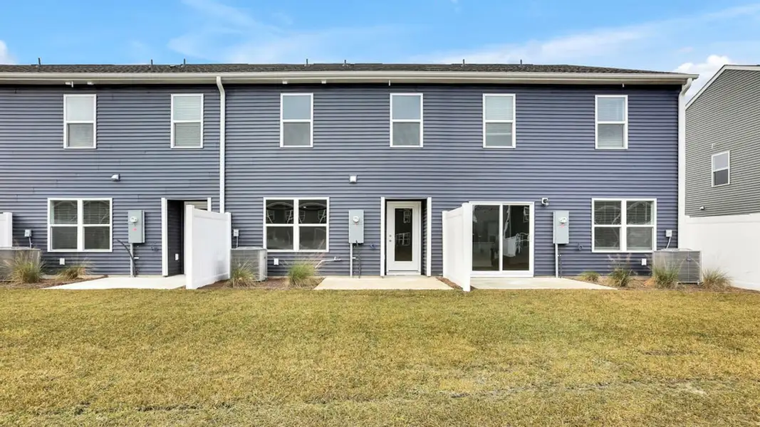 Exterior details and patio area of a home in Grayson Park Townhomes, Leland (Image 3).