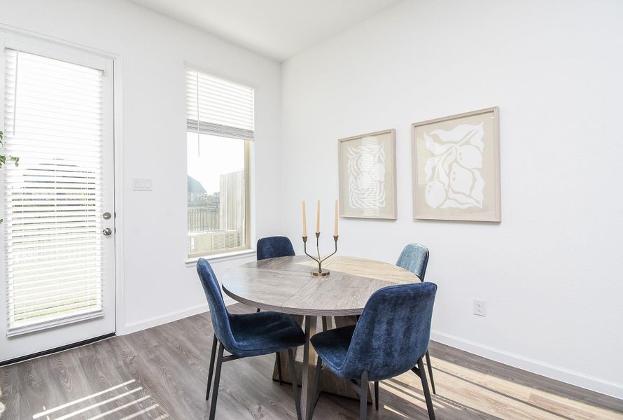 A sunlit dining area adjacent to the kitchen with plenty of space for family meals.