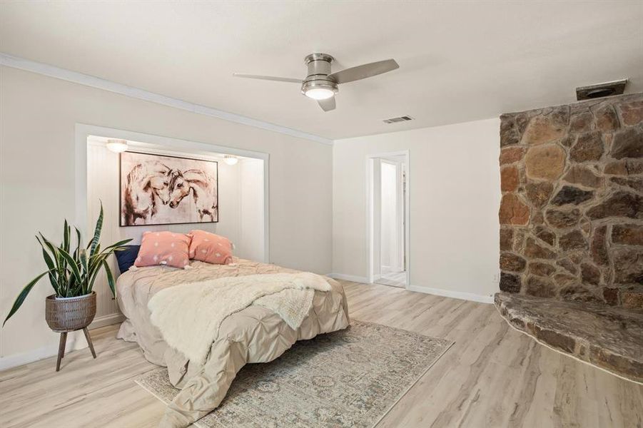 Primary Bedroom featuring crown molding, light hardwood / wood-style flooring, and ceiling fan