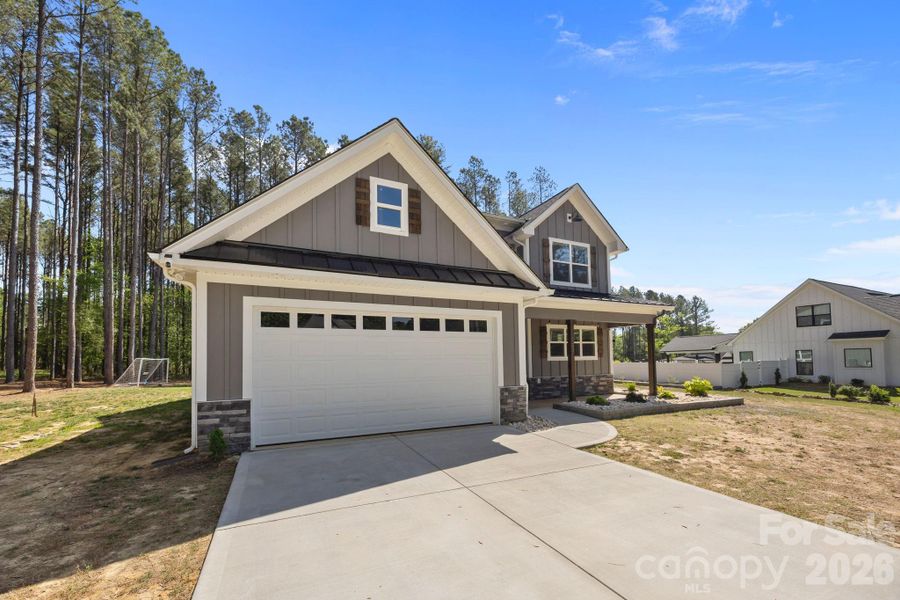 Front exterior of a new home in , Monroe, NC, highlighting curb appeal (Image 23).