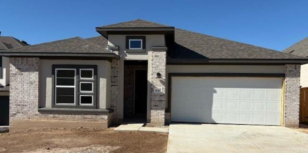 Prairie-style home featuring a garage