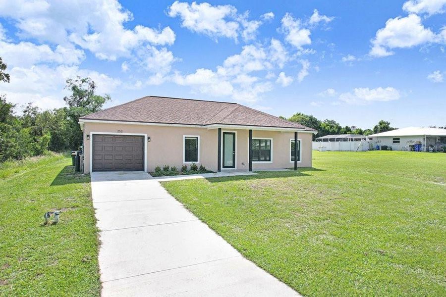 Front exterior of a new home in , Lake Placid, FL, highlighting curb appeal (Image 16). Front exterior of a new home in , Lake Placid, FL, highlighting curb appeal (Image 16).