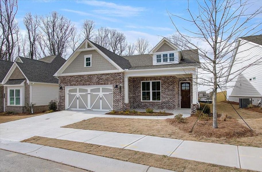 Front exterior of a new home in Courtyards at Traditions, Cumming, GA, highlighting curb appeal (Image 23).