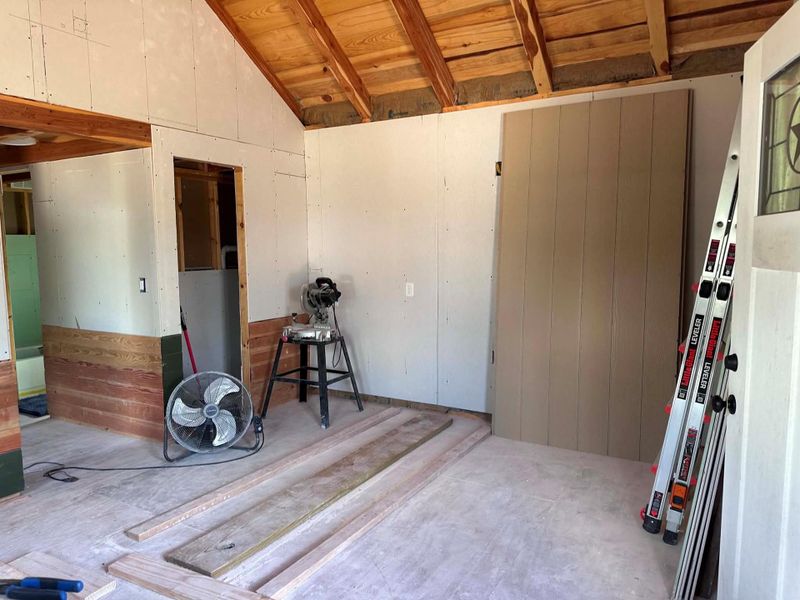 Exposed wood beam ceilings add rustic charm to this room under construction.
