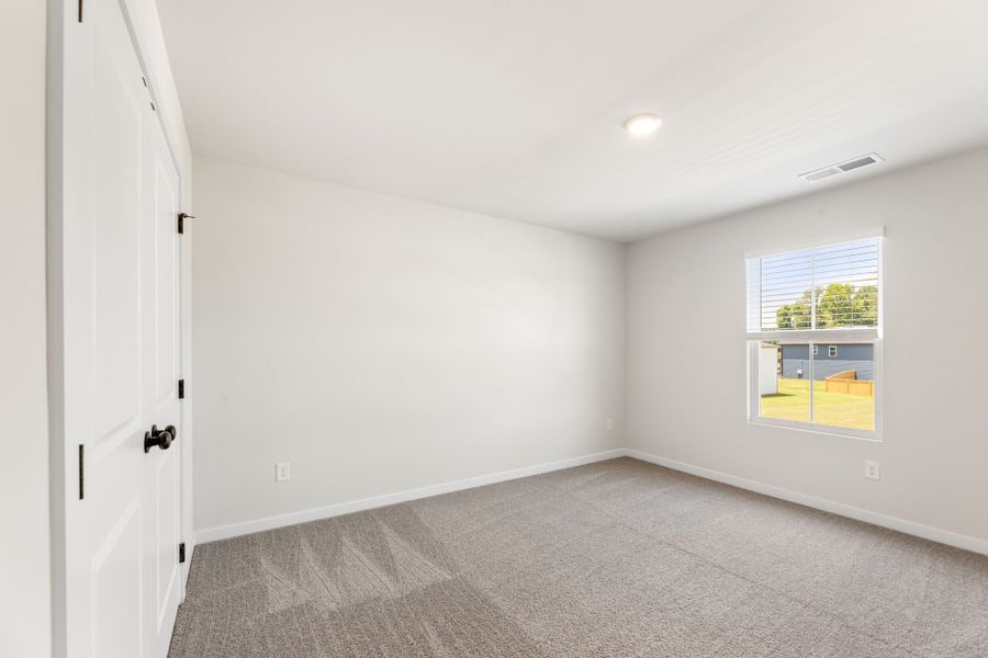 A room with a carpet and a window. A room with a carpet and a window.