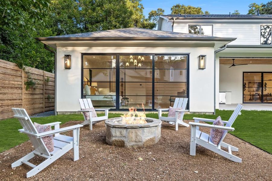 Back of property featuring a fire pit and a patio area