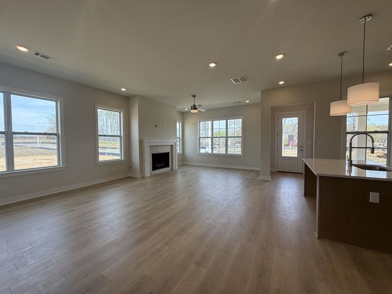 Unfurnished living room featuring recessed lighting, a fireplace, ceiling fan, and light wood-style floors