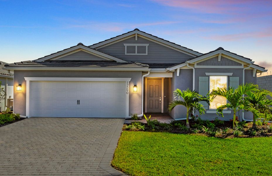 Front exterior of a new home in Del Webb Oak Creek, North Fort Myers, FL, highlighting curb appeal (Image 1). Front exterior of a new home in Del Webb Oak Creek, North Fort Myers, FL, highlighting curb appeal (Image 1).