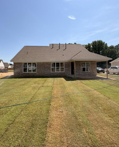 Brick exterior with a gabled roof and covered patio