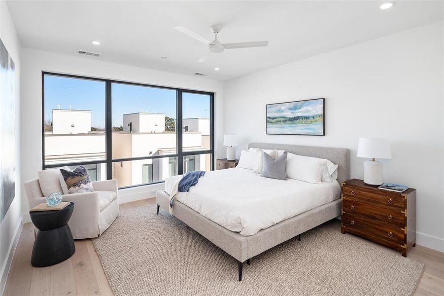 Bedroom featuring ceiling fan and light hardwood / wood-style flooring