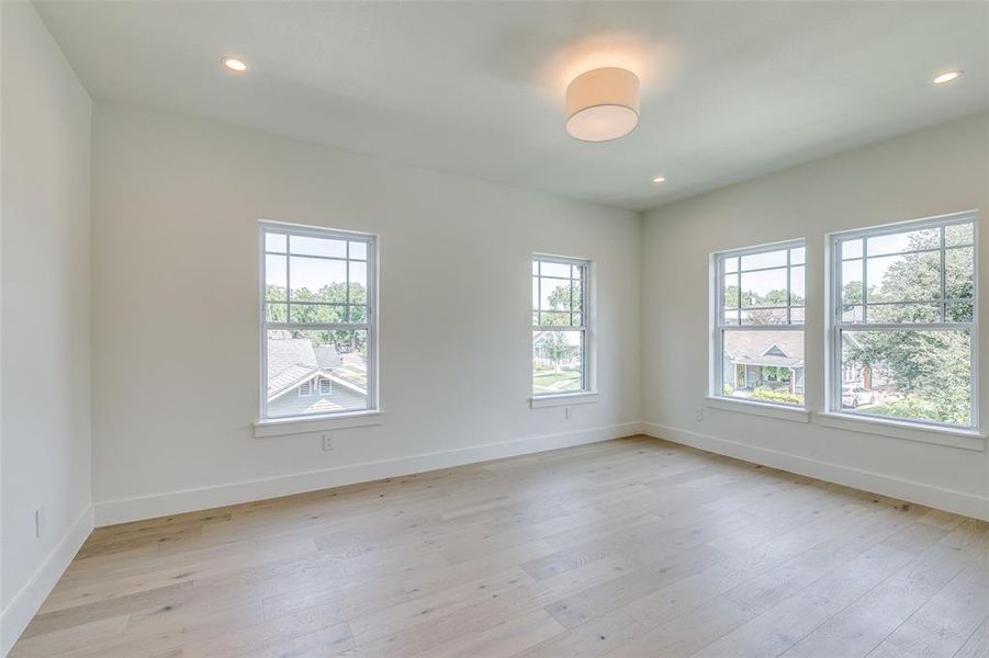 Empty room with light hardwood / wood-style flooring