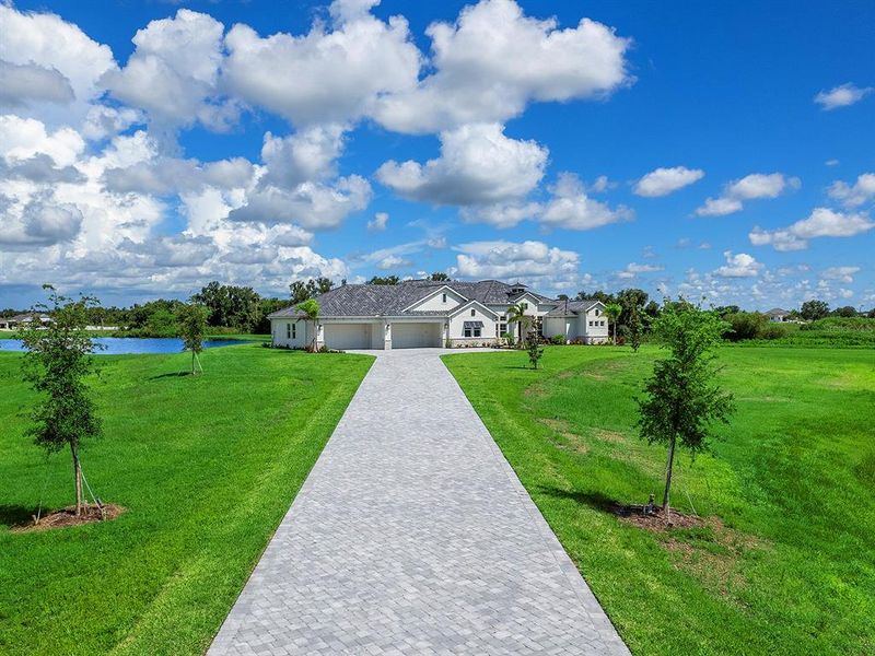 Front exterior of a new home in Hampton Lakes, Sarasota, FL, highlighting curb appeal (Image 22).
